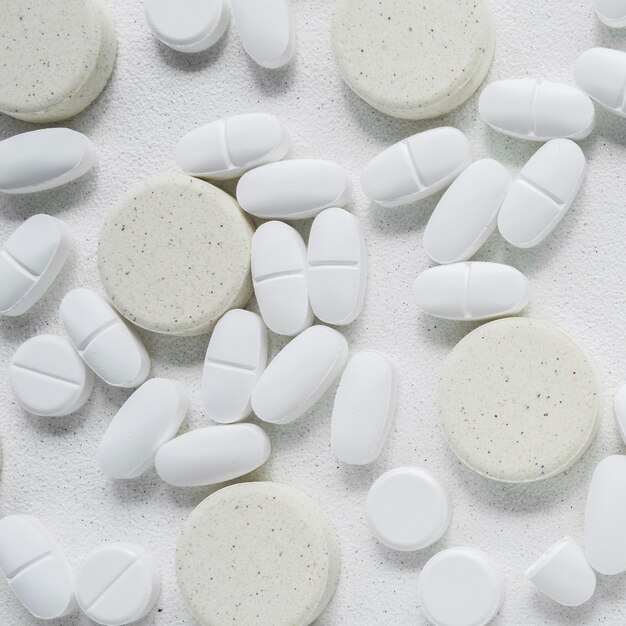 White and grey pills on white background