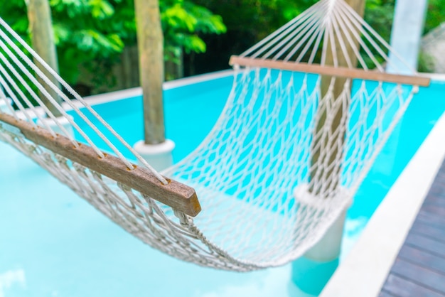 Free photo white hammocks in luxury swimming pool .