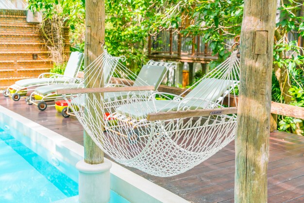 White hammocks in Luxury swimming pool .