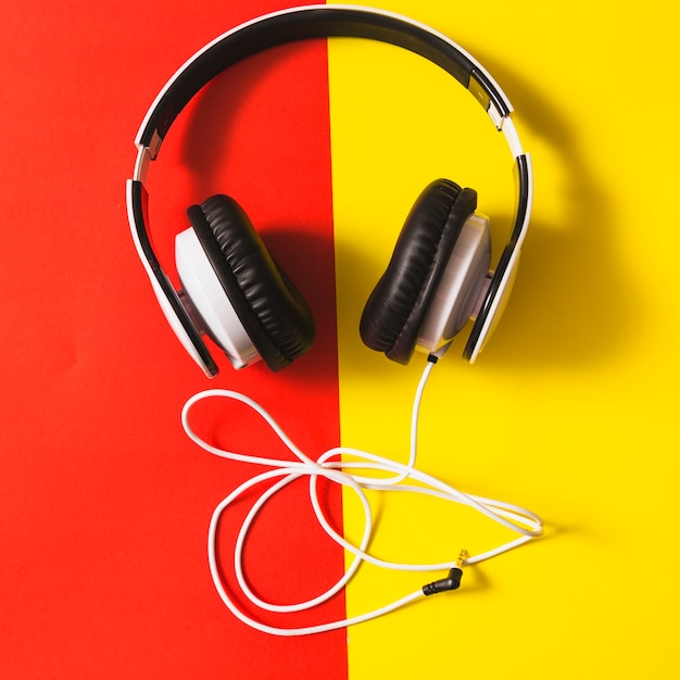 White headphone over the dual red and yellow background