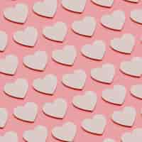 Free photo white hearts on pink