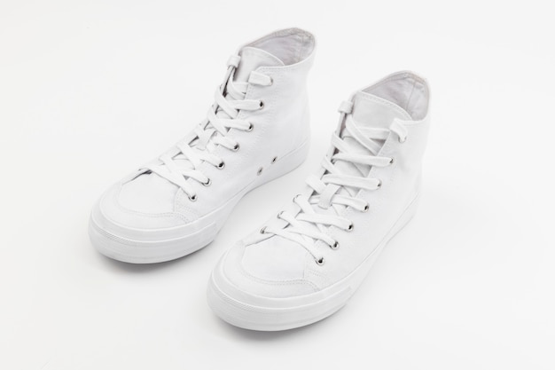 Free photo white high top sneakers unisex footwear fashion