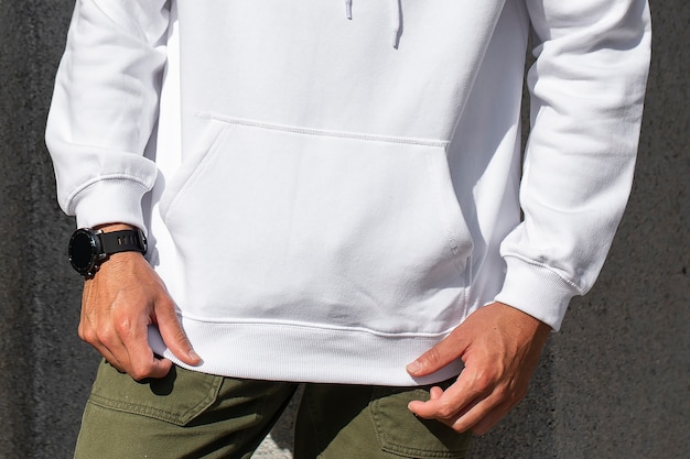 Free photo white hoodie on man with green pants closeup photoshoot