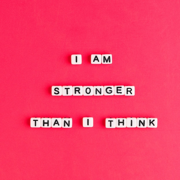 White I AM STRONGER THAN I THINK beads words typography on red