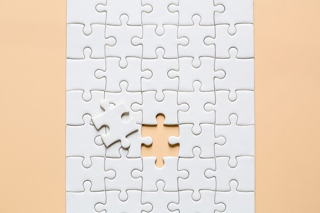 white jigsaw puzzle pieces on pink