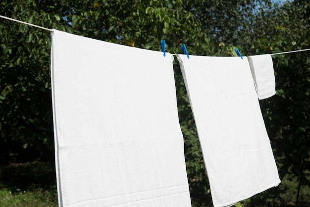 Free photo white laundry hanging on a string outdoors