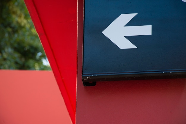 white left arrow on blue background outdoors