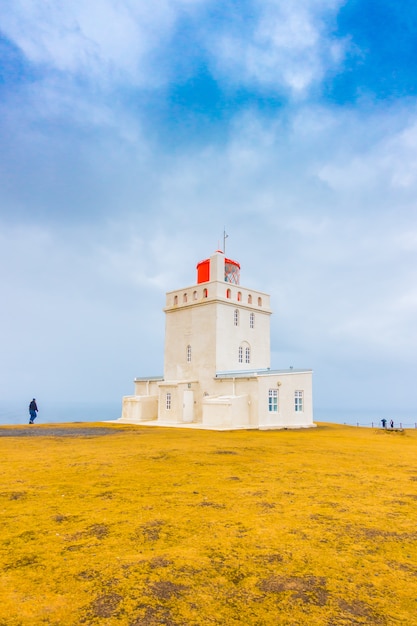 Free photo white lighthouse at cape dyrholaey, iceland. .