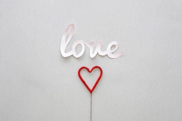 White Love inscription with heart on stick 