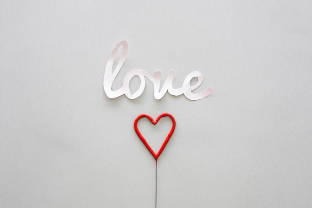 White Love inscription with heart on stick 