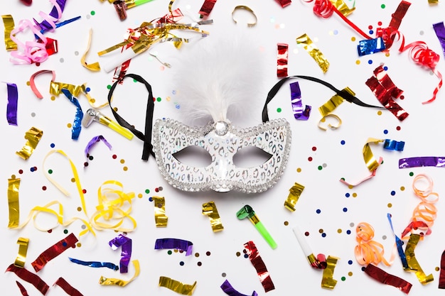 Free photo white mask on confetti