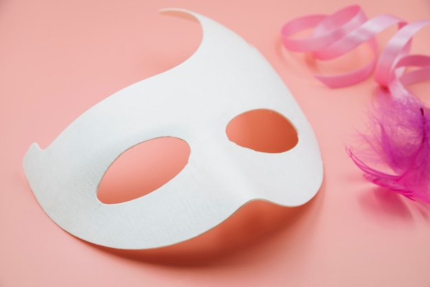 White mask mockup with feathers