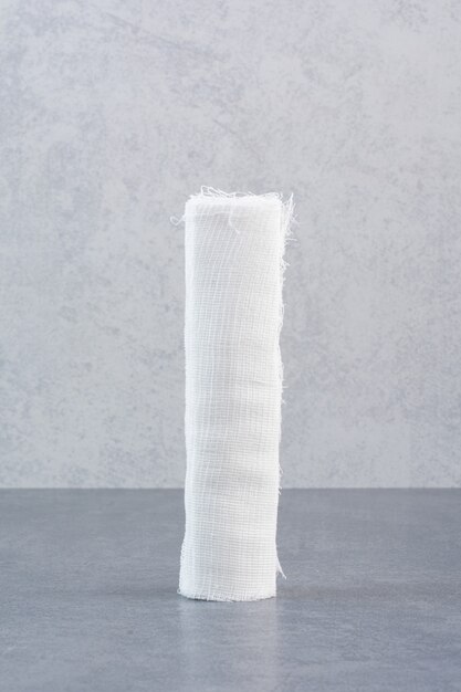 White medical bandage on marble table.