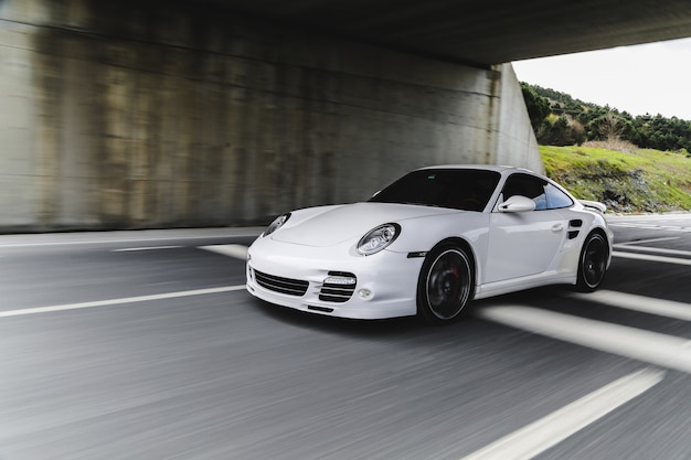 White mini coupe on the road.