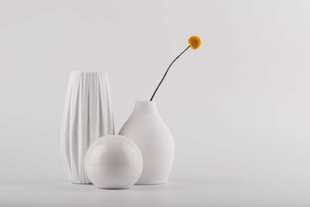 White modern vases with plant arrangement