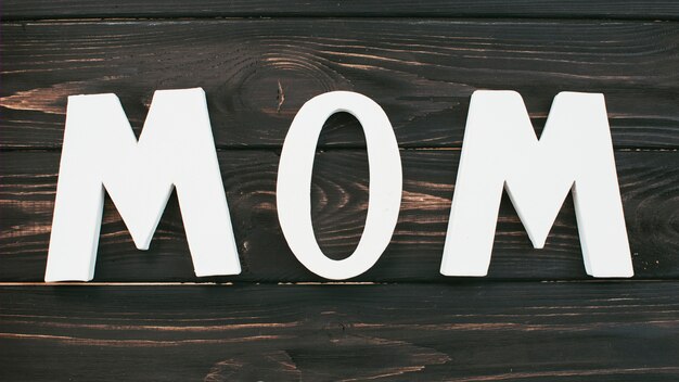 White Mom inscription on wooden table