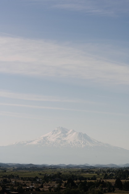 Free Photo white mountain near town under a clear sky
