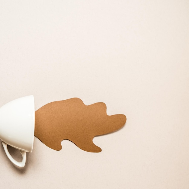 White Mug with spilled paper coffee Space for text top view