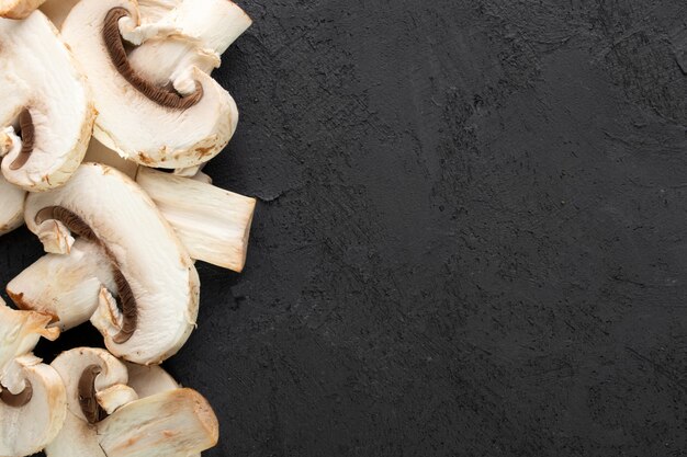 White mushrooms on dark desk