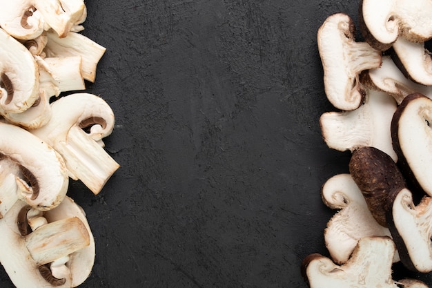 Free photo white mushrooms on dark desk