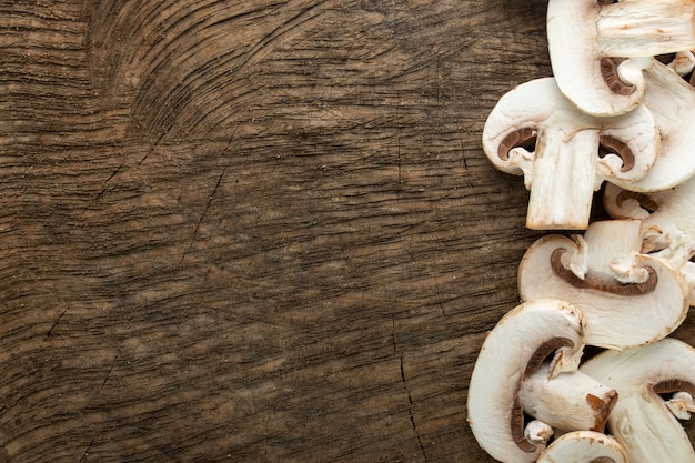 White mushrooms fresh sliced on brown wooden desk