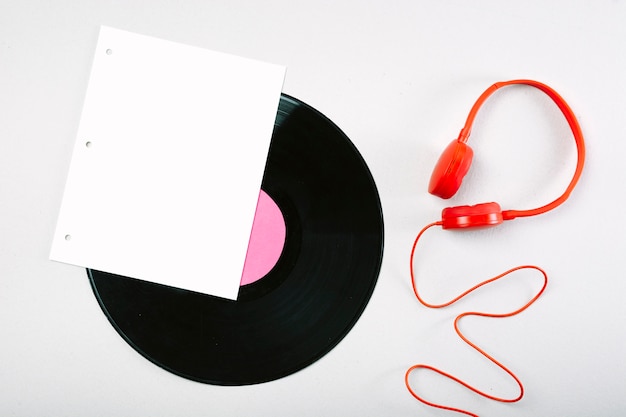 Free photo white page; vinyl record and red headphone on white background