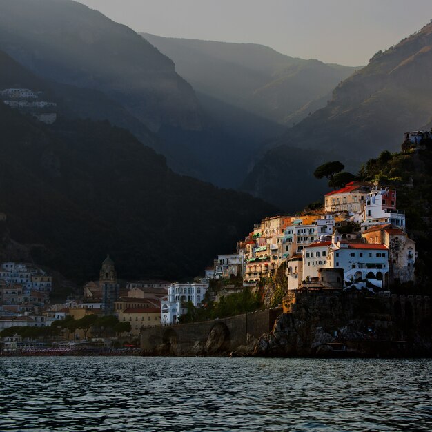 White painted buildings beside body of water