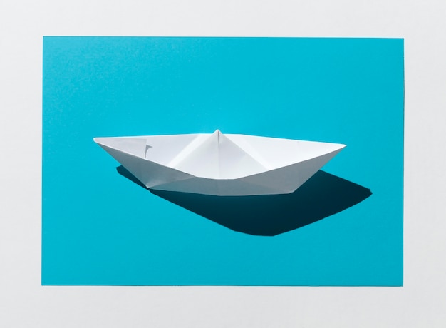 Free photo white paper boat high angle