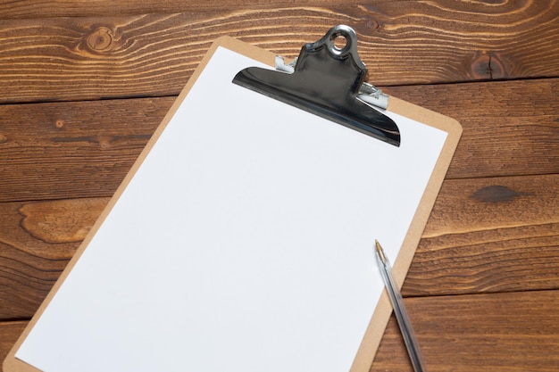 White paper clipboard on wood background