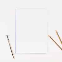 Free photo white paper with pencils