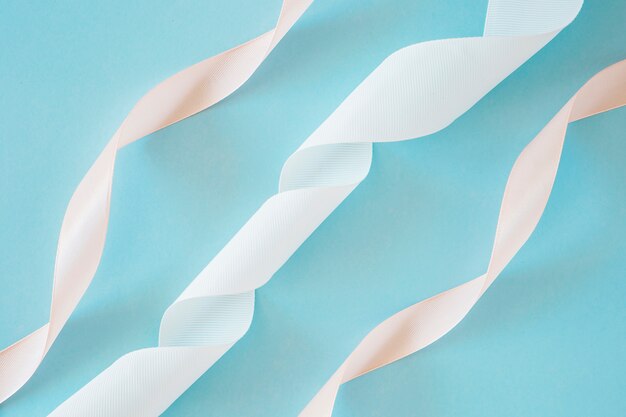 White and peach stain ribbon on blue backdrop