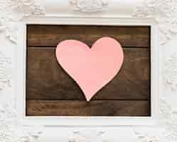 Free photo white photo frame with flower patterns and symbol of heart