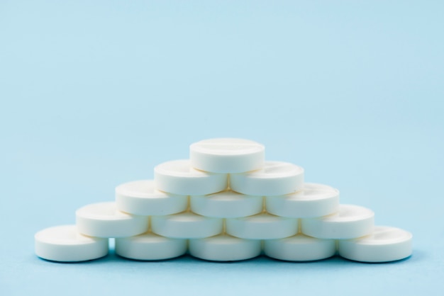 Free photo white pills arrangement on blue background