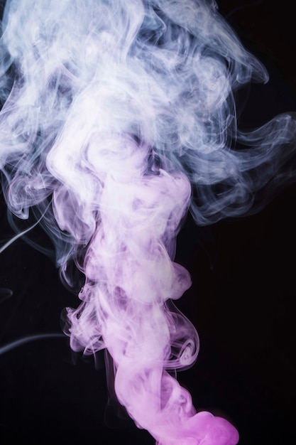 Free photo white and pink smoke fumes on black background