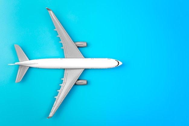 White plane airplane on a blue background flat lay copy space