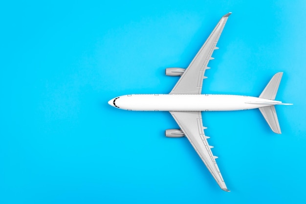 White plane airplane on a blue background flat lay copy space