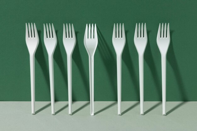 White plastic forks leaning on a wall