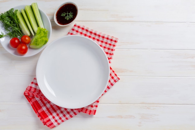 White plate ceramic on wihte wooden surface