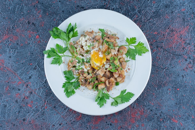 Un piatto bianco di uova fritte con erbe aromatiche.