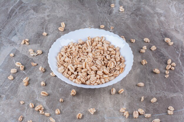 A white plate full of crisped rice breakfast cereal . 