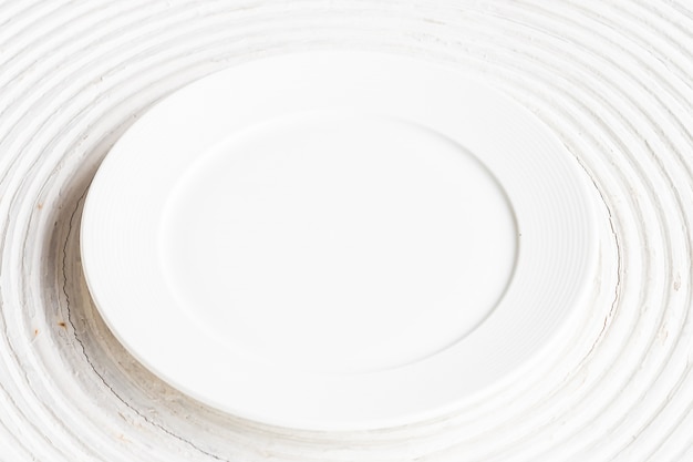 White plate on white wood background