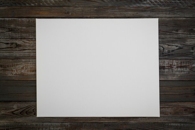White poster on a wooden background