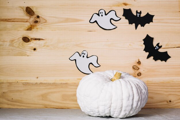 White pumpkin with Halloween decorationson wall