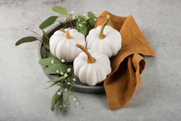 White pumpkins on cloth high angle