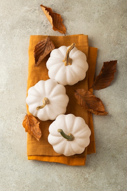 White pumpkins and cloths arrangement top view