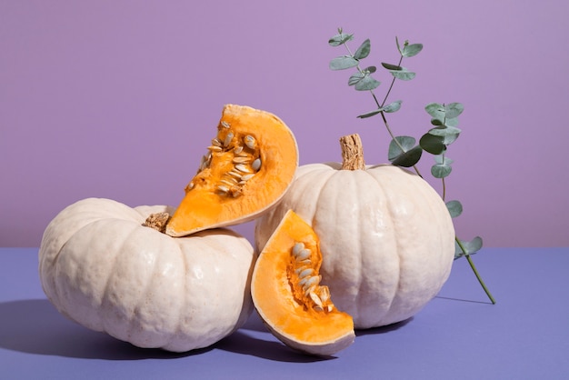 White pumpkins with purple background