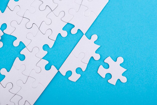 White puzzle pieces and blue background