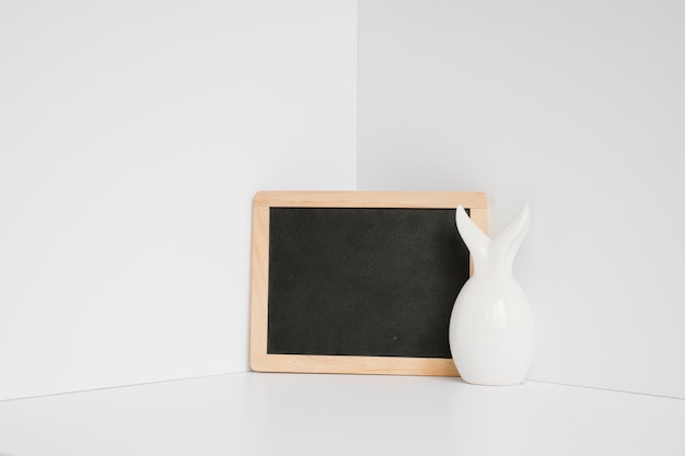 White rabbit figurine at blackboard