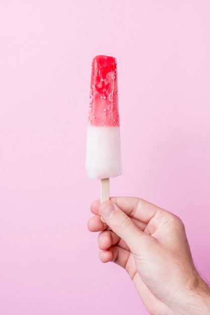 white and red cold ice cream on stick
