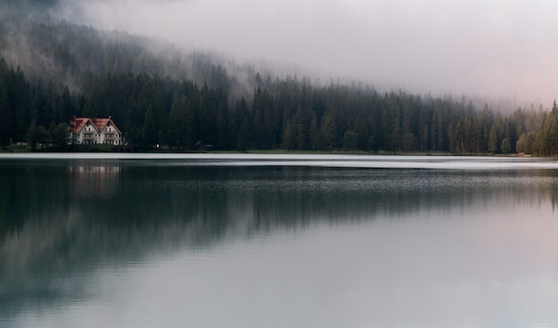 Free photo white and red house under fog